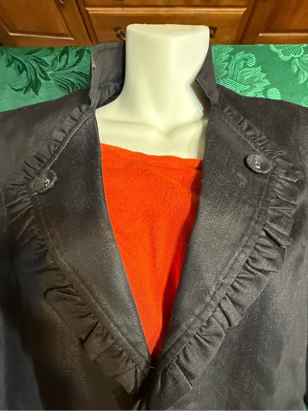 Women’s black blazer, ruffle detail, and buttons